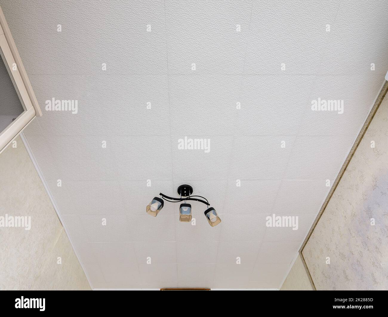 A fragment of the interior, a view of a modest ceiling with glued