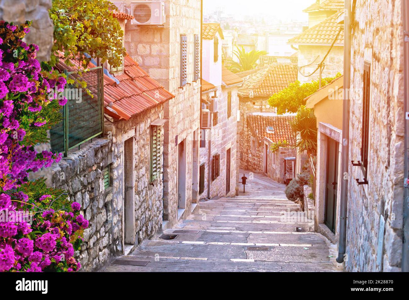 Old stone street of Split historic city sun haze view Stock Photo
