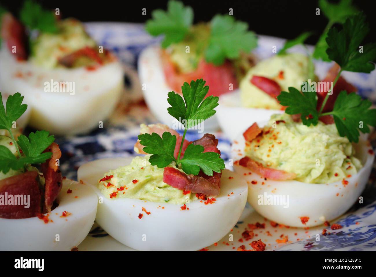 deviled eggs appetizer with avocado and bacon Stock Photo
