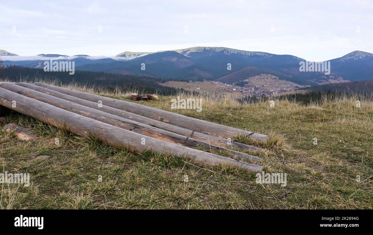 Autumn landscape in the Carpathians with mountain peaks and felled tree trunks. The concept of ecology and illegal deforestation in western Ukraine. Stock Photo