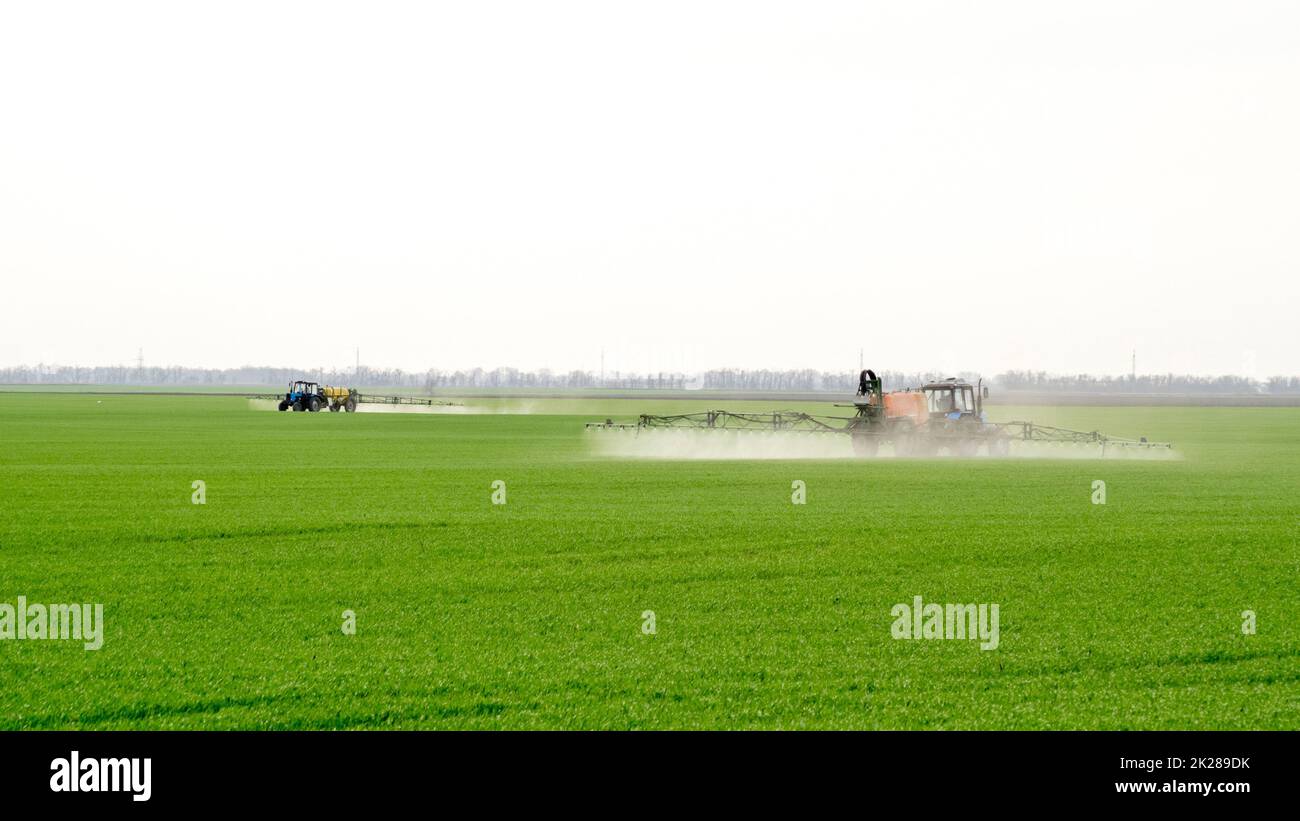 Tractor with a spray device for finely dispersed fertilizer. Stock Photo