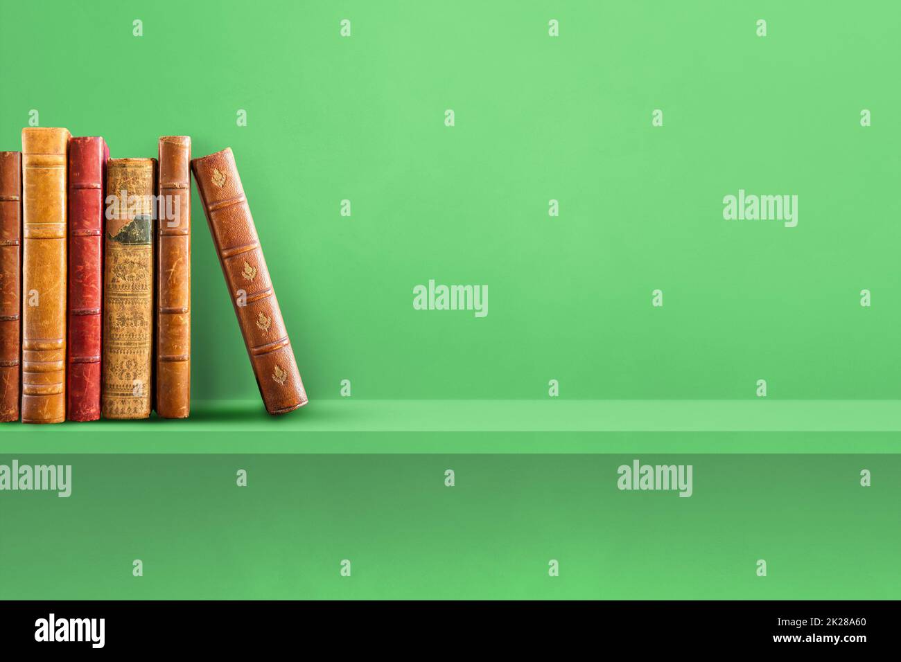Row of old books on green shelf. Horizontal background Stock Photo - Alamy