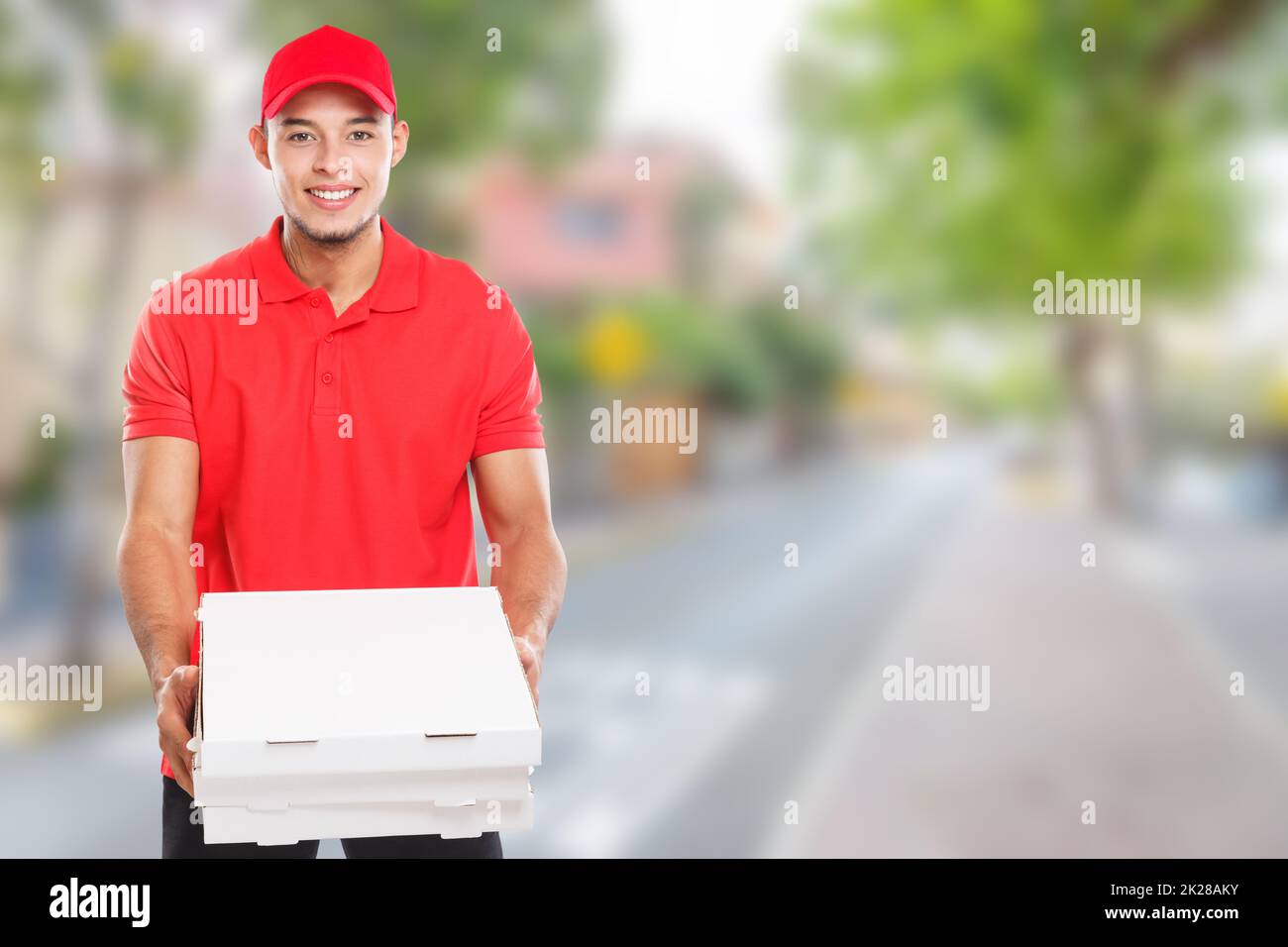 Pizza fast food delivery young latin man town copyspace copy space order delivering deliver Stock Photo