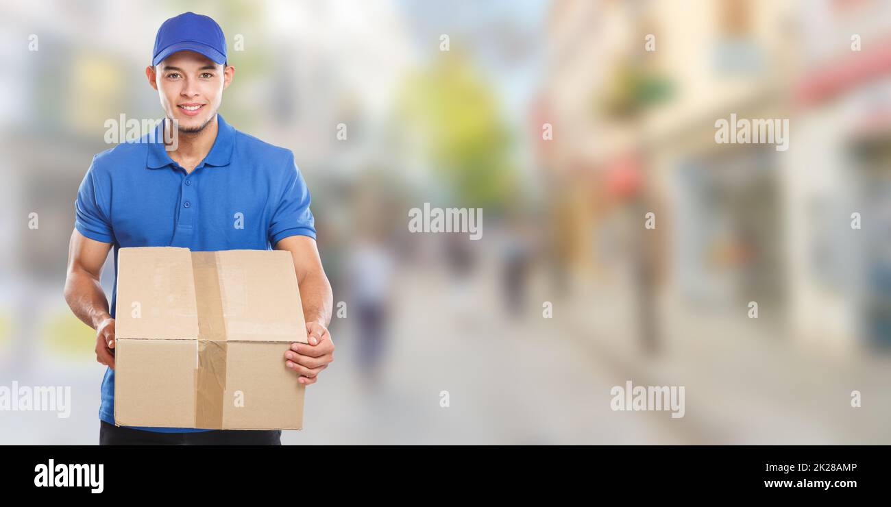 Parcel delivery service box package delivering town banner copyspace copy space job logistics young man Stock Photo