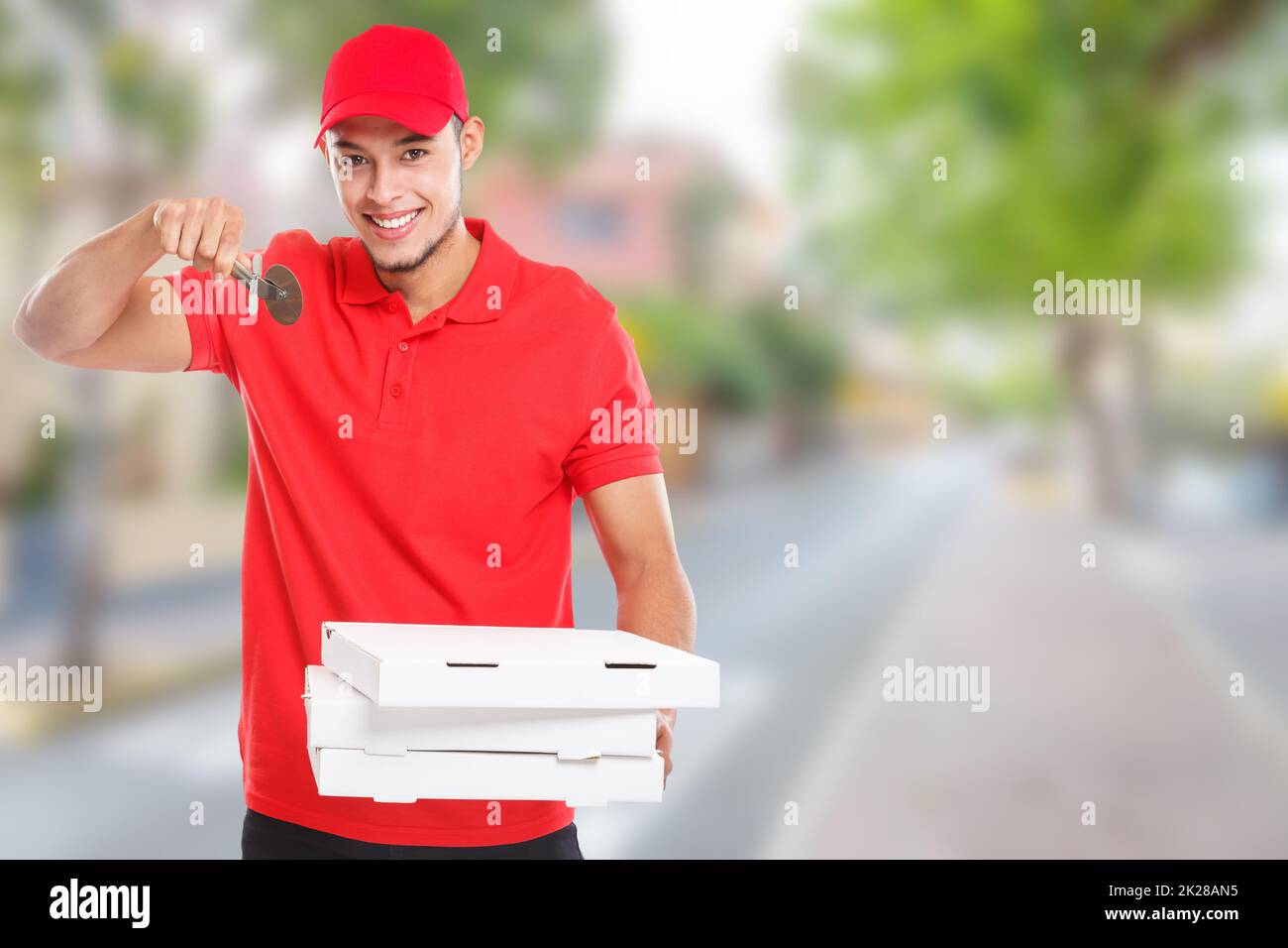 Pizza cutter fast food delivery smiling young latin man town copyspace copy space delivering deliver Stock Photo