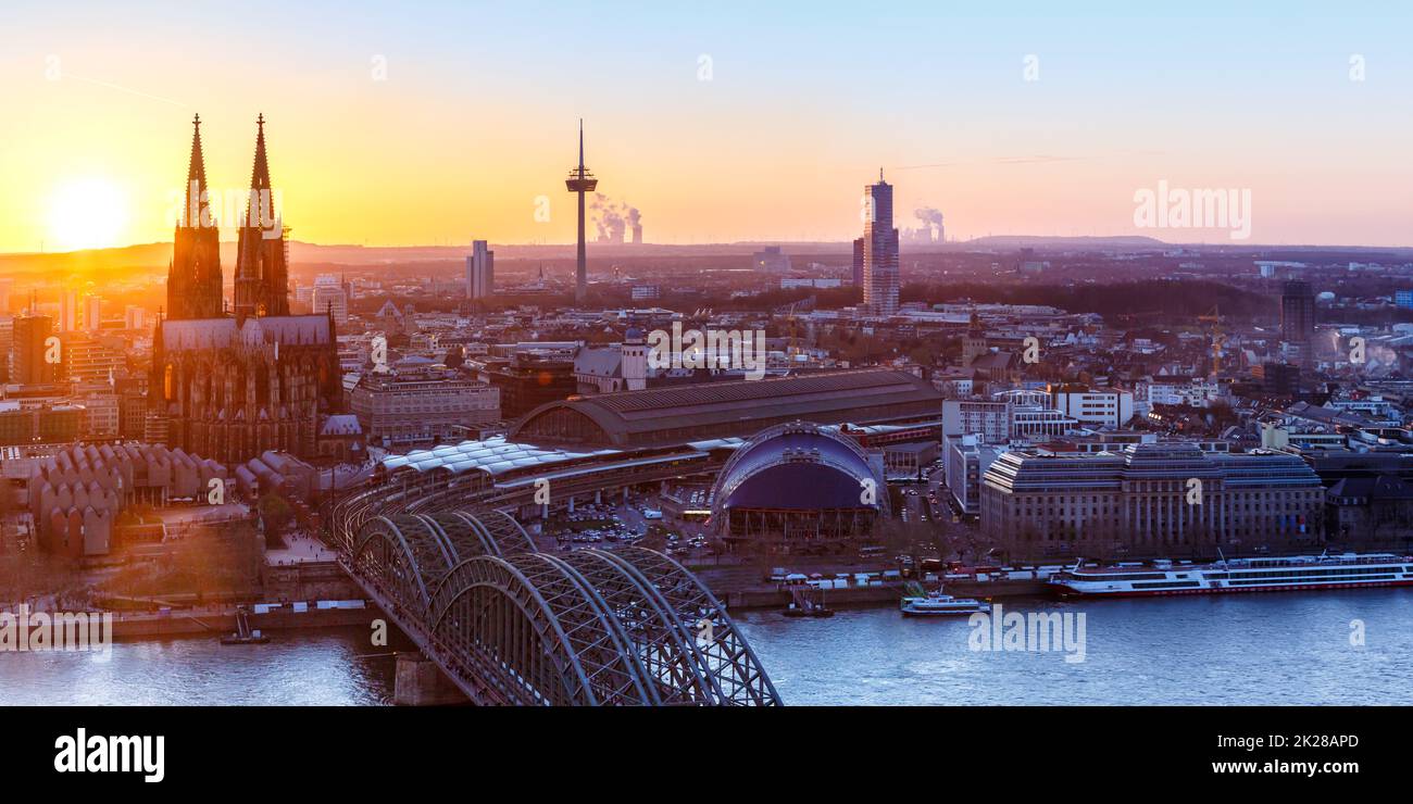 Cologne Cathedral church panorama panoramic view Germany skyline city town sunset bridge Stock Photo
