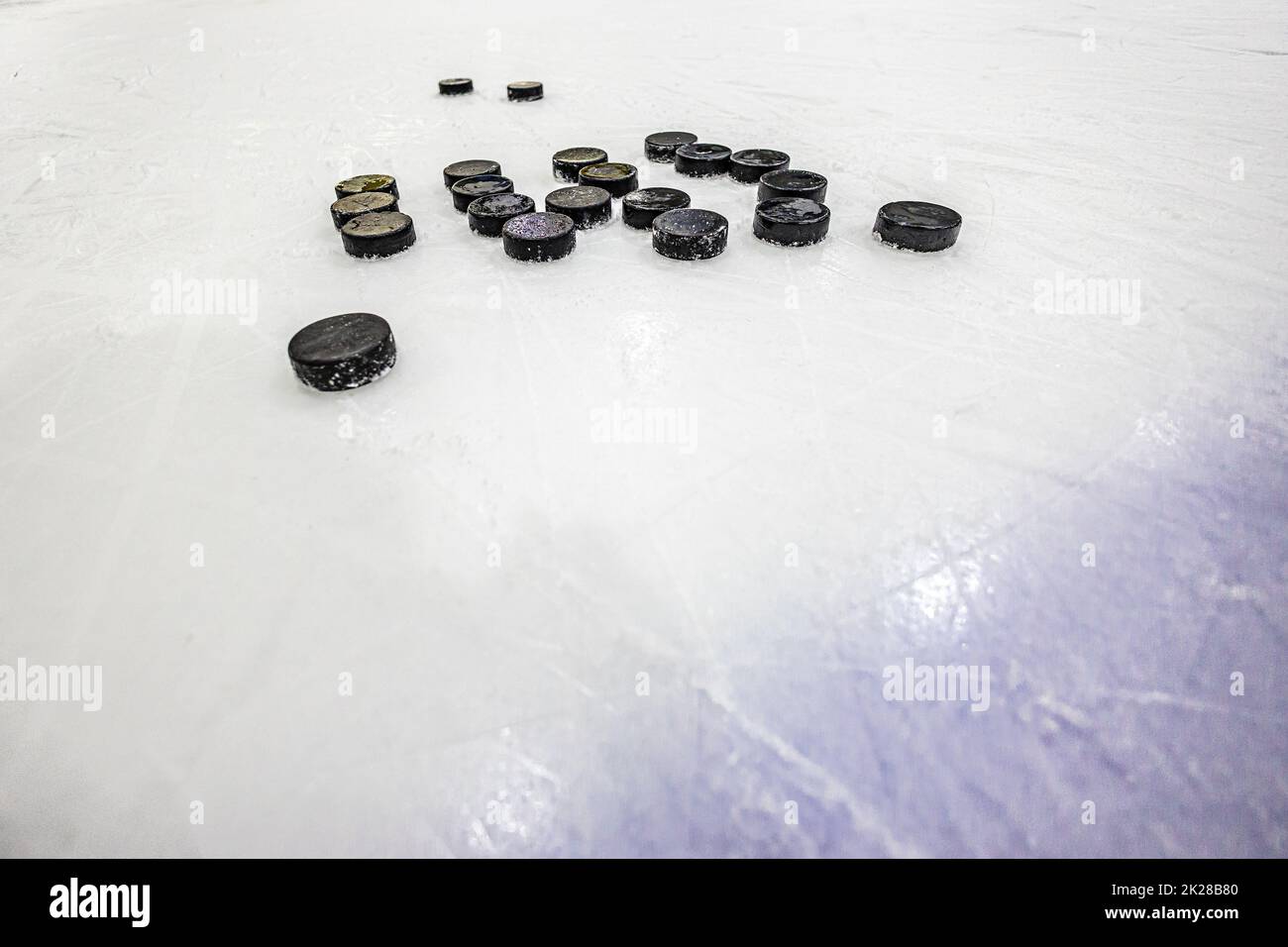 pucks on empty ice rink Stock Photo Alamy