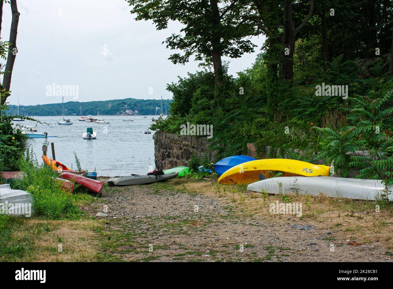A residenceonly beach and boat launch lined with kayaks and canoes in