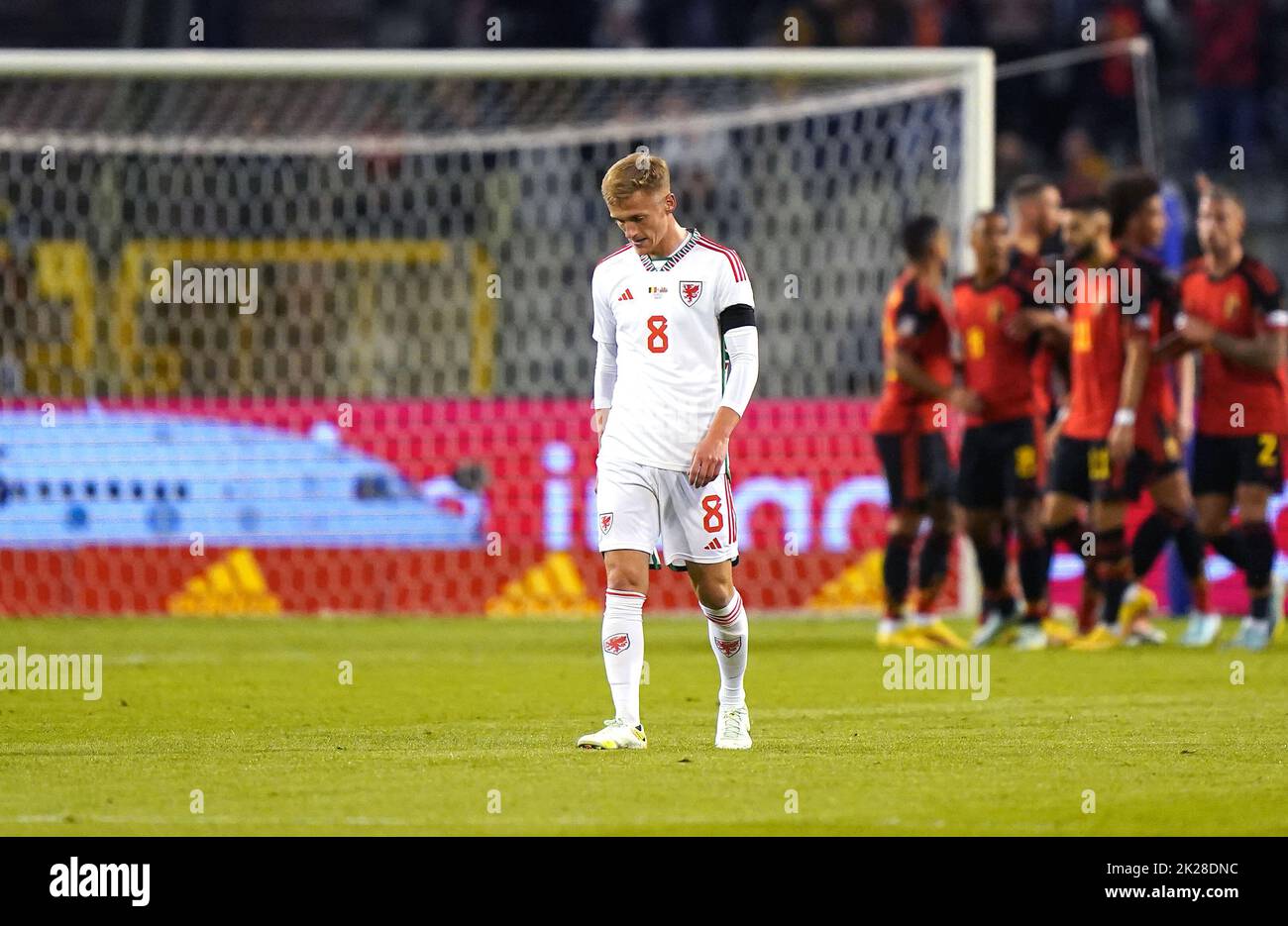 Wales' Matthew Smith looks dejected after Belgium's Kevin De Bruyne (hidden) celebrates scoring their side's first goal of the game with team-mtes during the UEFA Nations League Group D Match at King Baudouin Stadium, Brussels. Picture date: Thursday September 22, 2022. Stock Photo