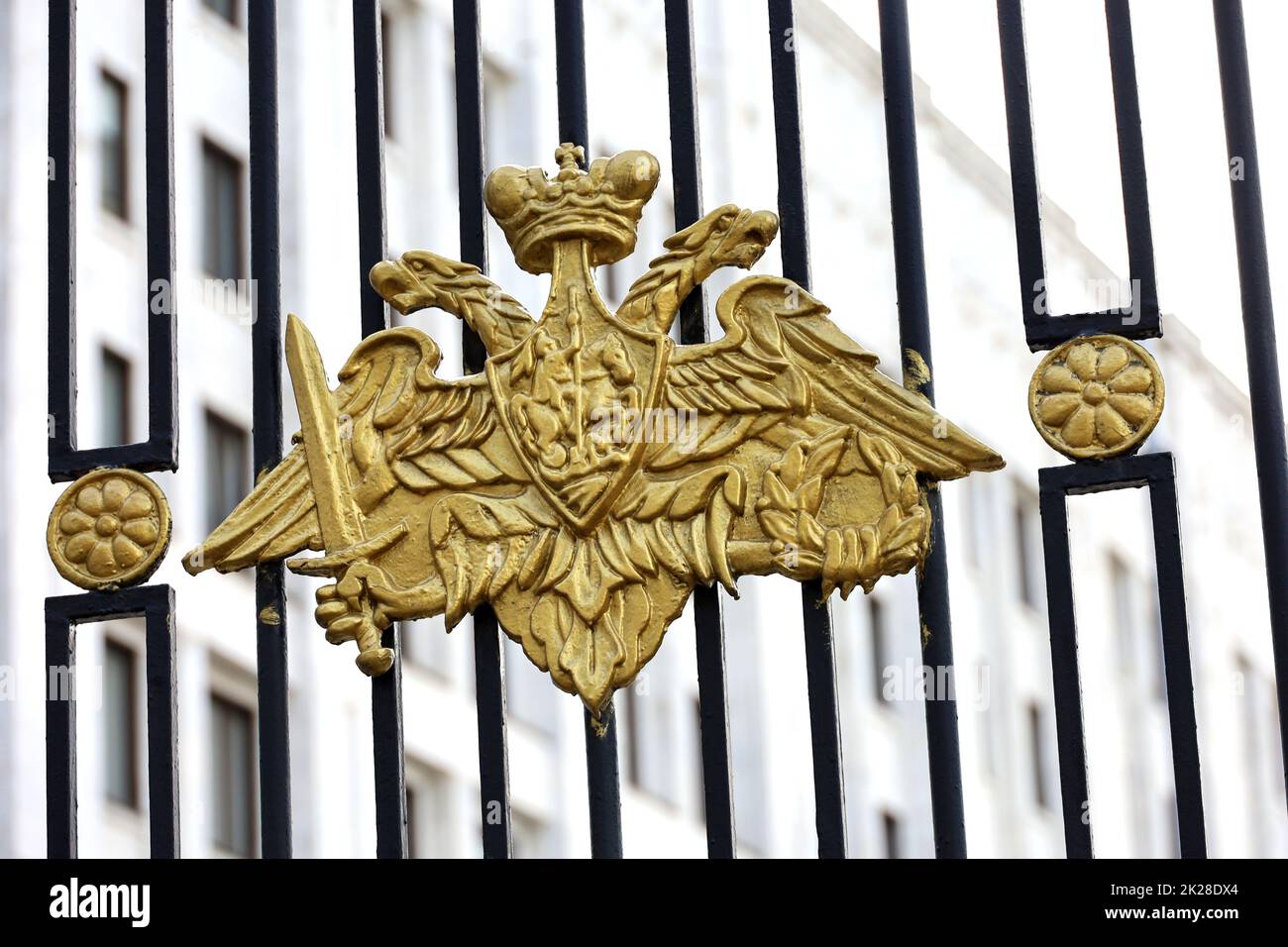 Official emblem of Defense Ministry of Russia on the metal fence, view to main office building in Moscow. Symbol of russian military, mobilization Stock Photo