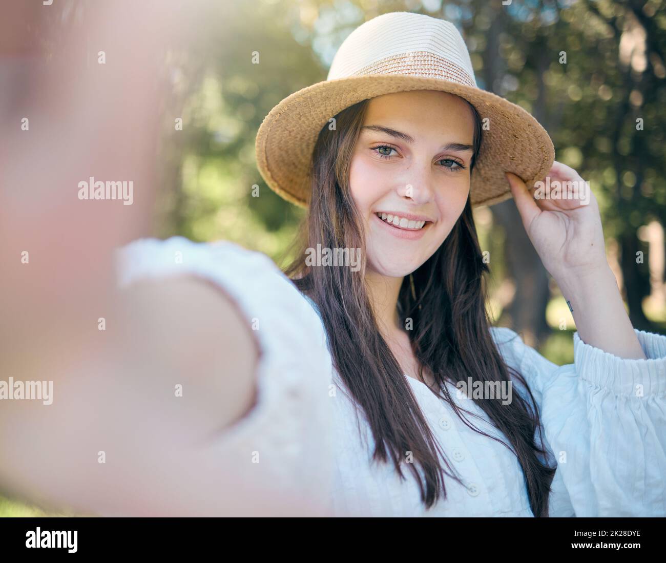 Selfie portrait of woman in nature park relax, happy and smile while in outdoor forest for peace, quiet and freedom. Happiness, trees and calm girl Stock Photo