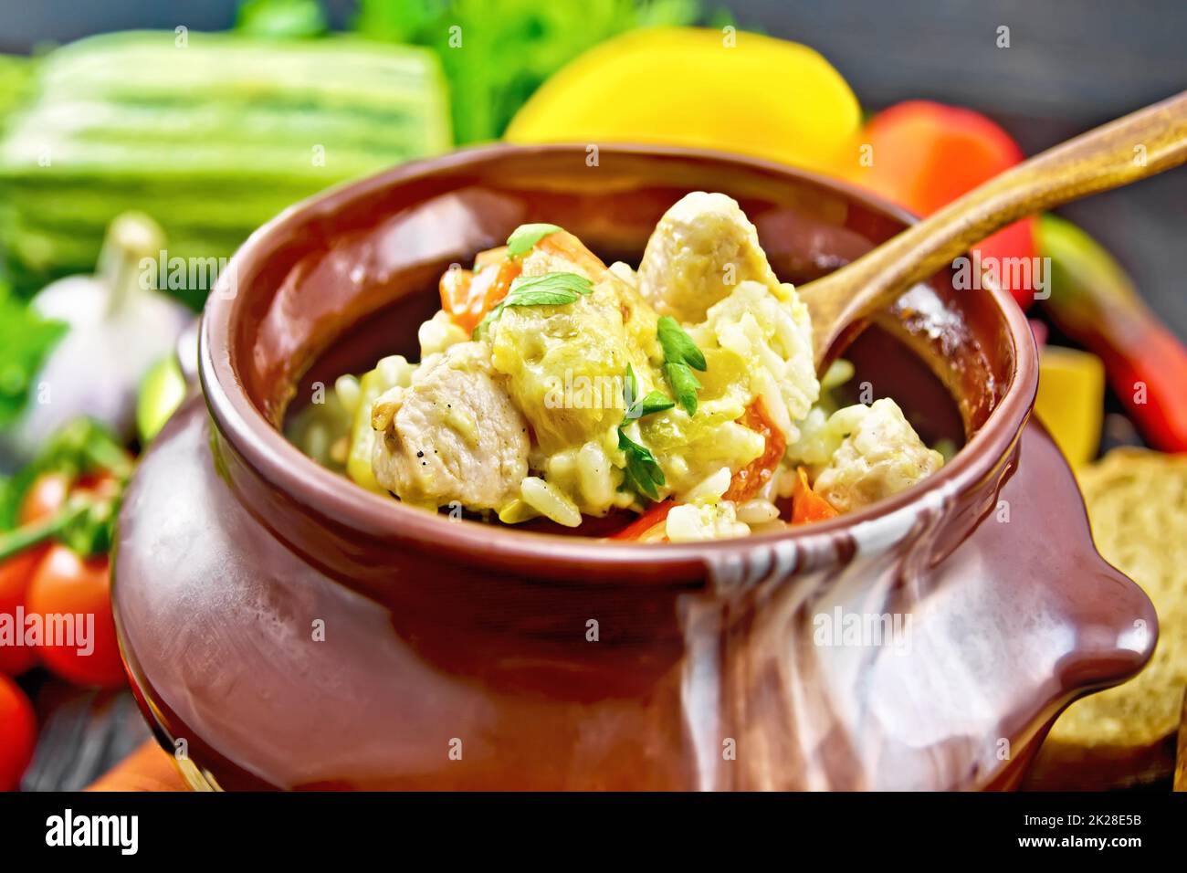 Rice With Chicken And Vegetables In Pot On Dark Board Stock Photo Alamy