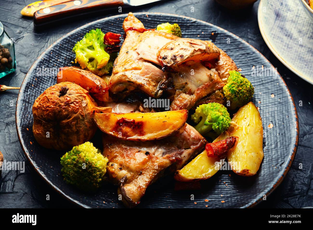 Appetizing baked chicken thighs. Stock Photo