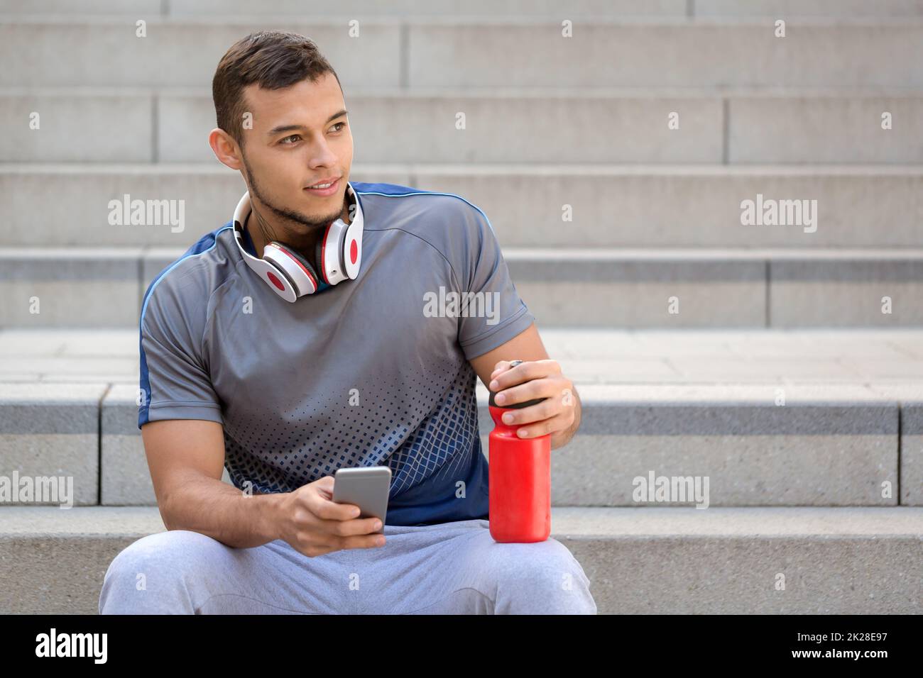 Young man listening to music listen headphones looking to the side copyspace copy space Stock Photo