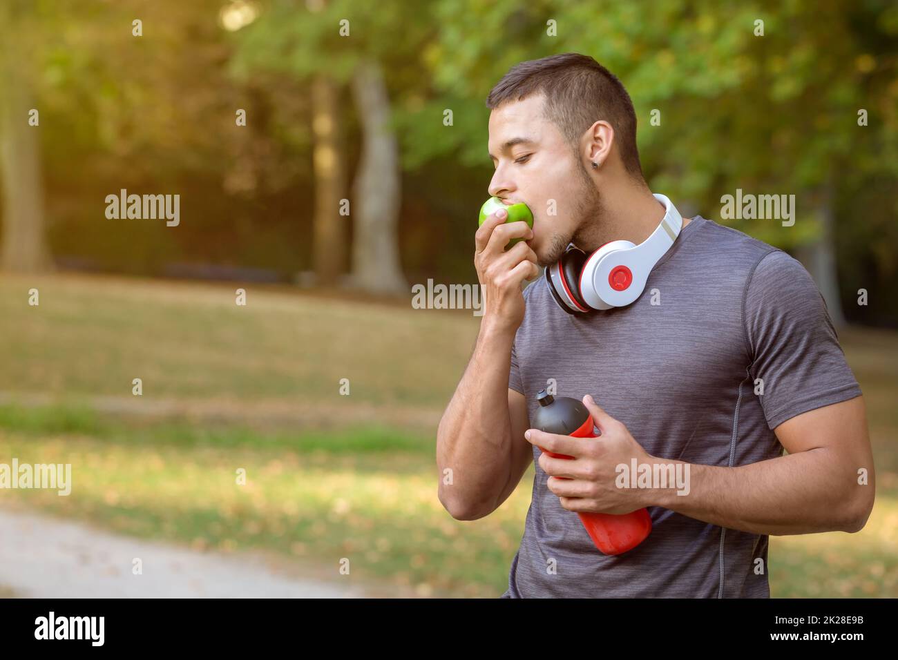 Runner young latin man eating an apple sports training fitness copyspace copy space Stock Photo