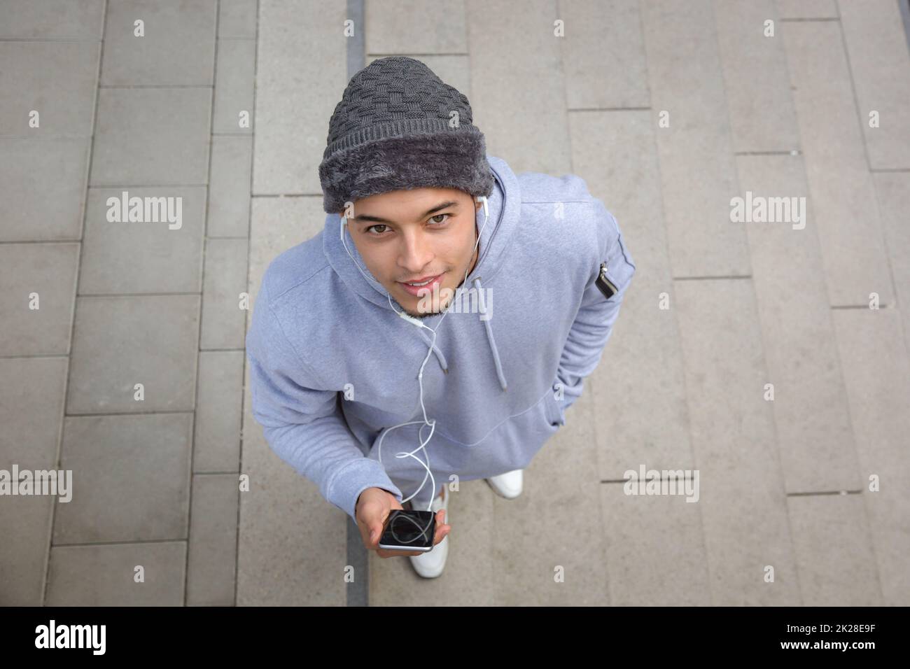 Listening to music young latin man runner sports training from above top view Stock Photo