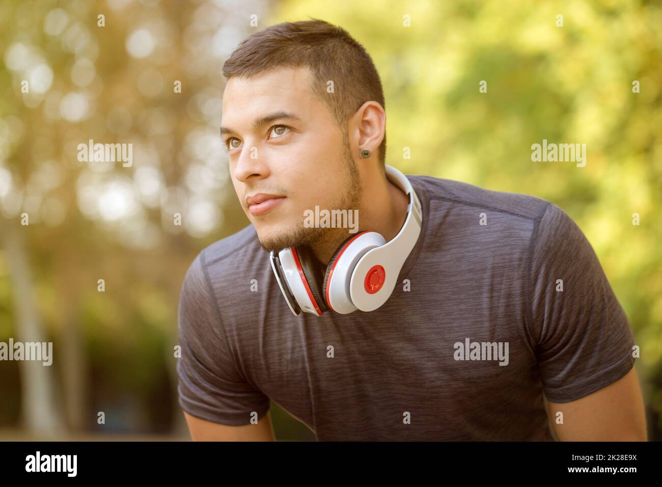 Young latin man runner looking up thinking copyspace copy space sports training fitness workout Stock Photo