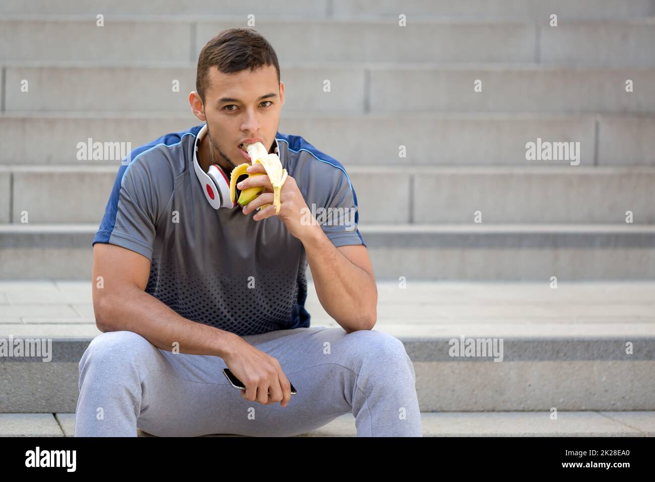 Young latin man eating banana fruit runner fitness copyspace copy space sports training Stock Photo