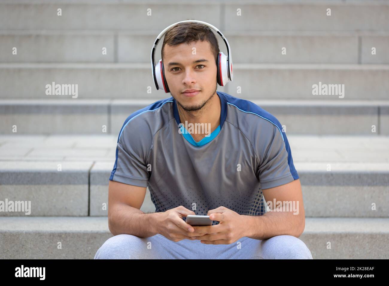 Listening to music young latin man with headphones listen smartphone smart phone Stock Photo