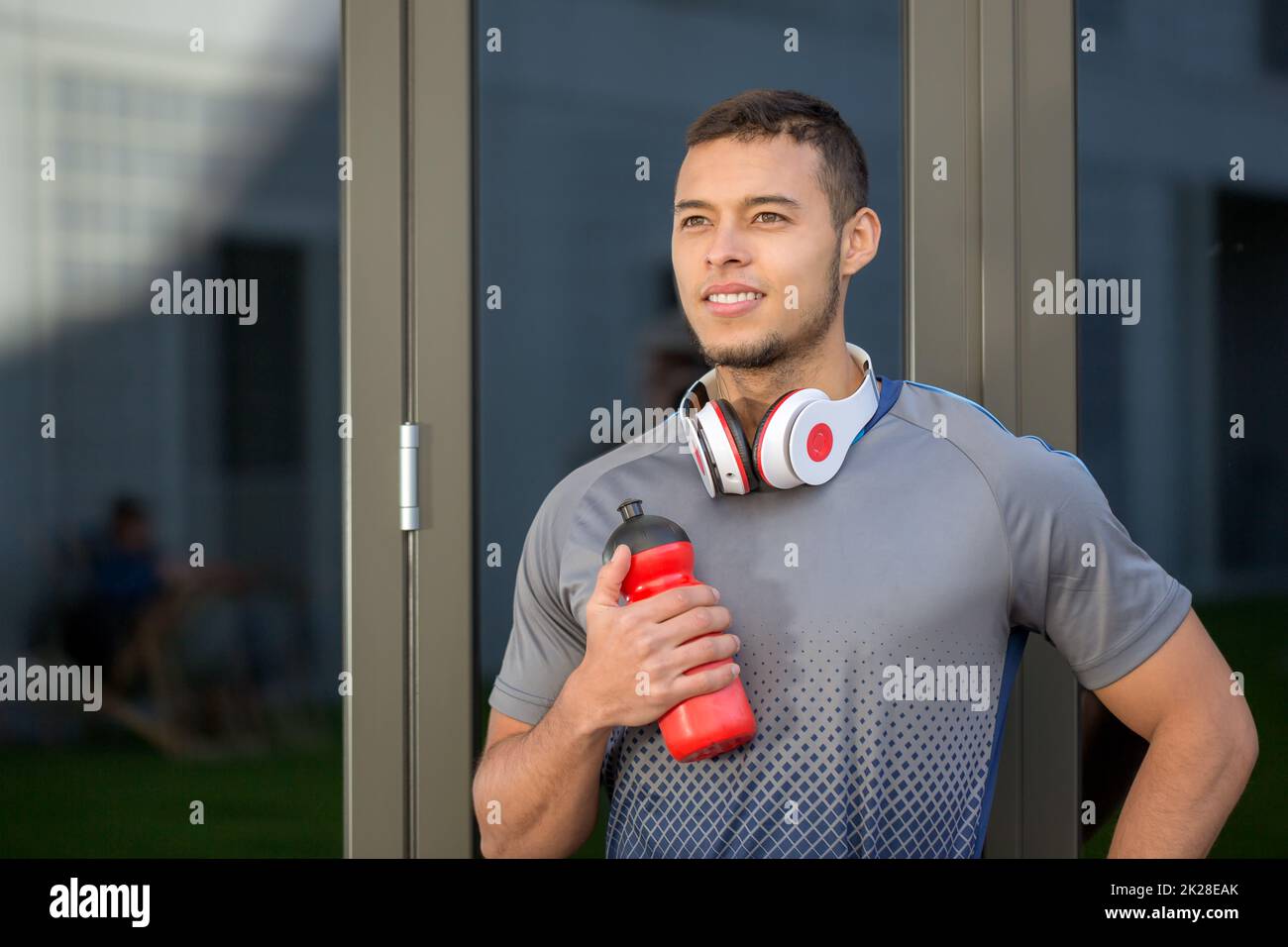 Young man looking up into the future runner outdoor sports fitness training Stock Photo