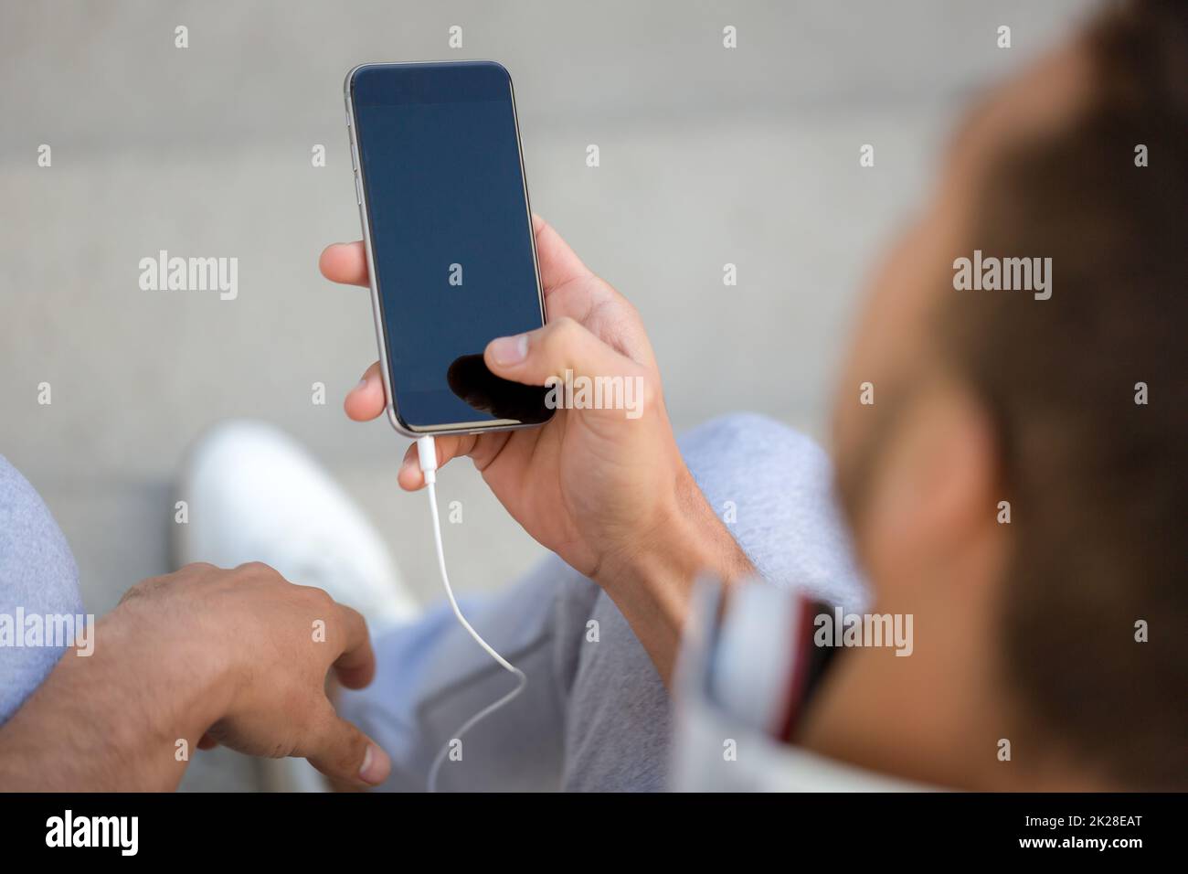 Young man looking at smartphone smart cell phone using cellphone copyspace copy space Stock Photo