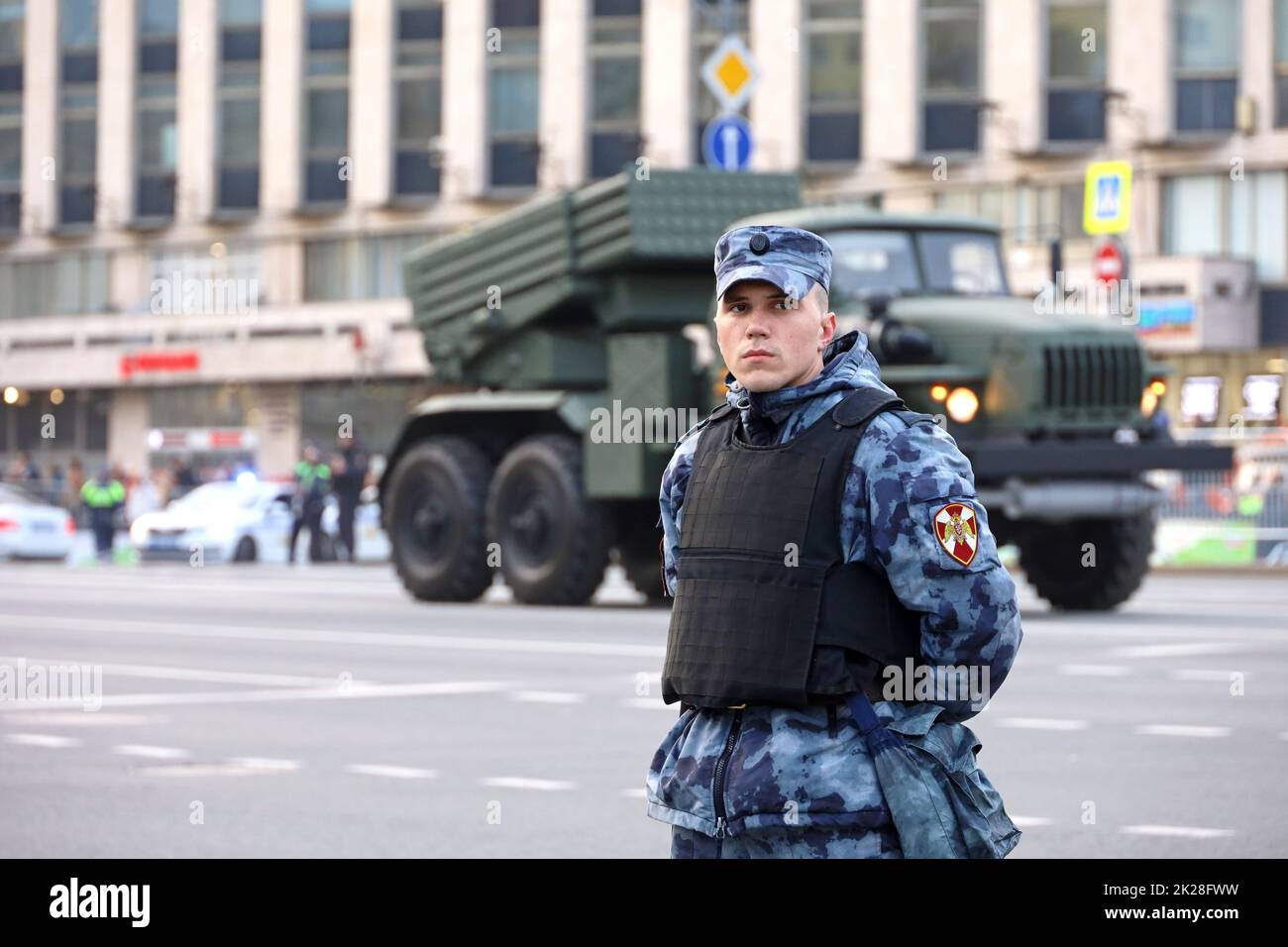 Russian soldier standing in front of multiple launch rocket system 'Tornado' on city street Stock Photo