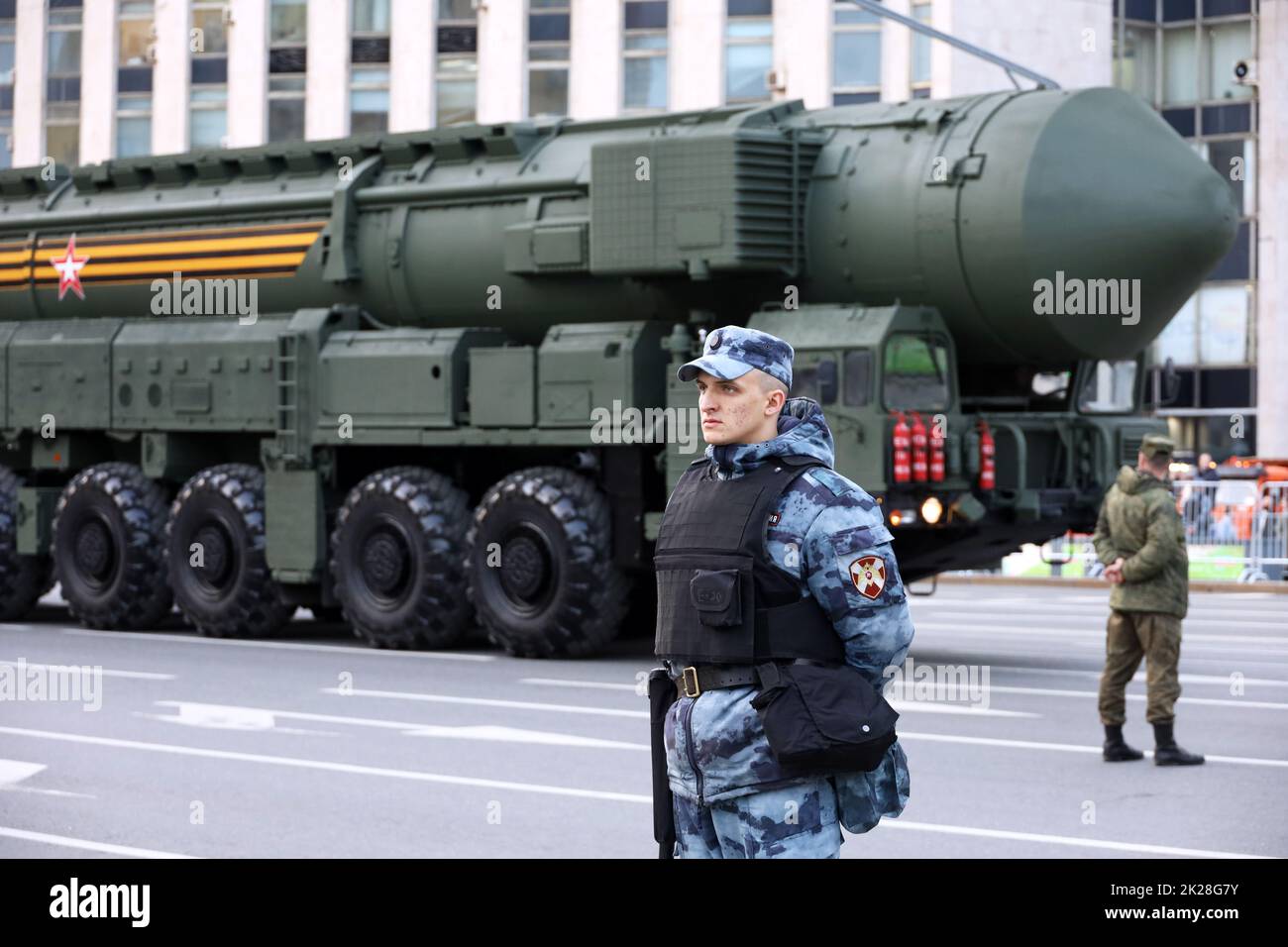 Soldiers of russian military forces standing on background of strategic missile system 'Yars' on city street, nuclear weapon Stock Photo