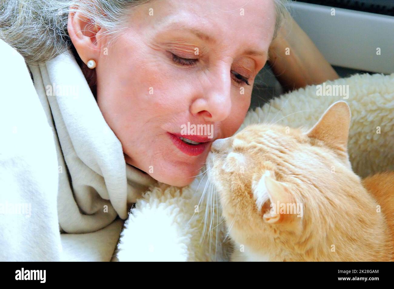 Female bonding with her kitten. Stock Photo