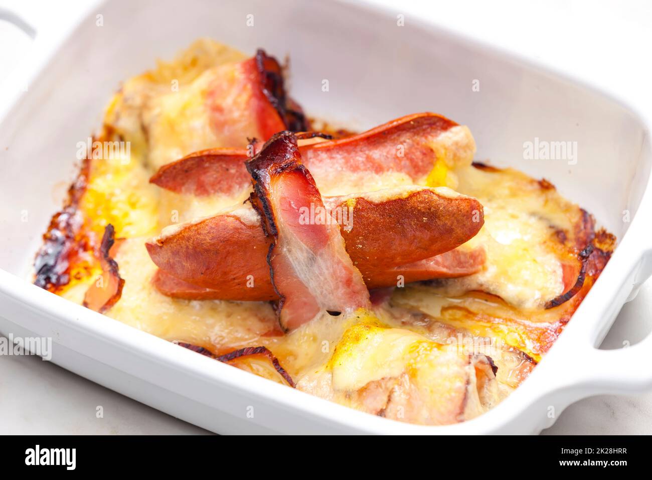 wurst in bacon baked with chedar cheese Stock Photo