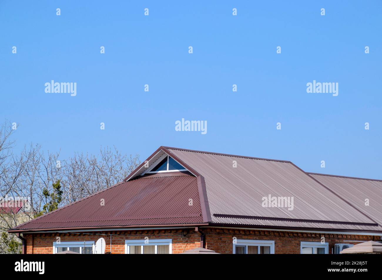 Metal roof brown. Construction of houses and types of roofing. Stock Photo