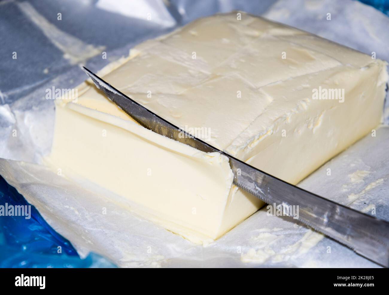 Cutting a butter knife. Butter and knife Stock Photo Alamy