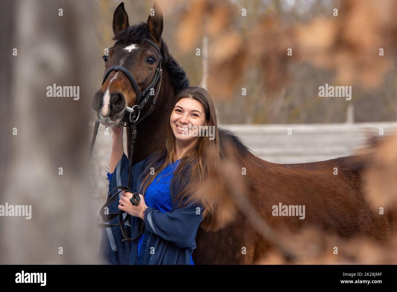Portrait of a happy beautiful girl of Slavic appearance and a horse Stock Photo