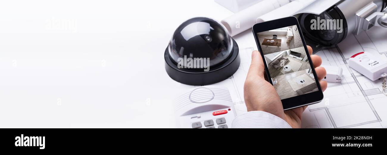 Smart Home Security Camera Surveillance. Mobile Technology Stock Photo
