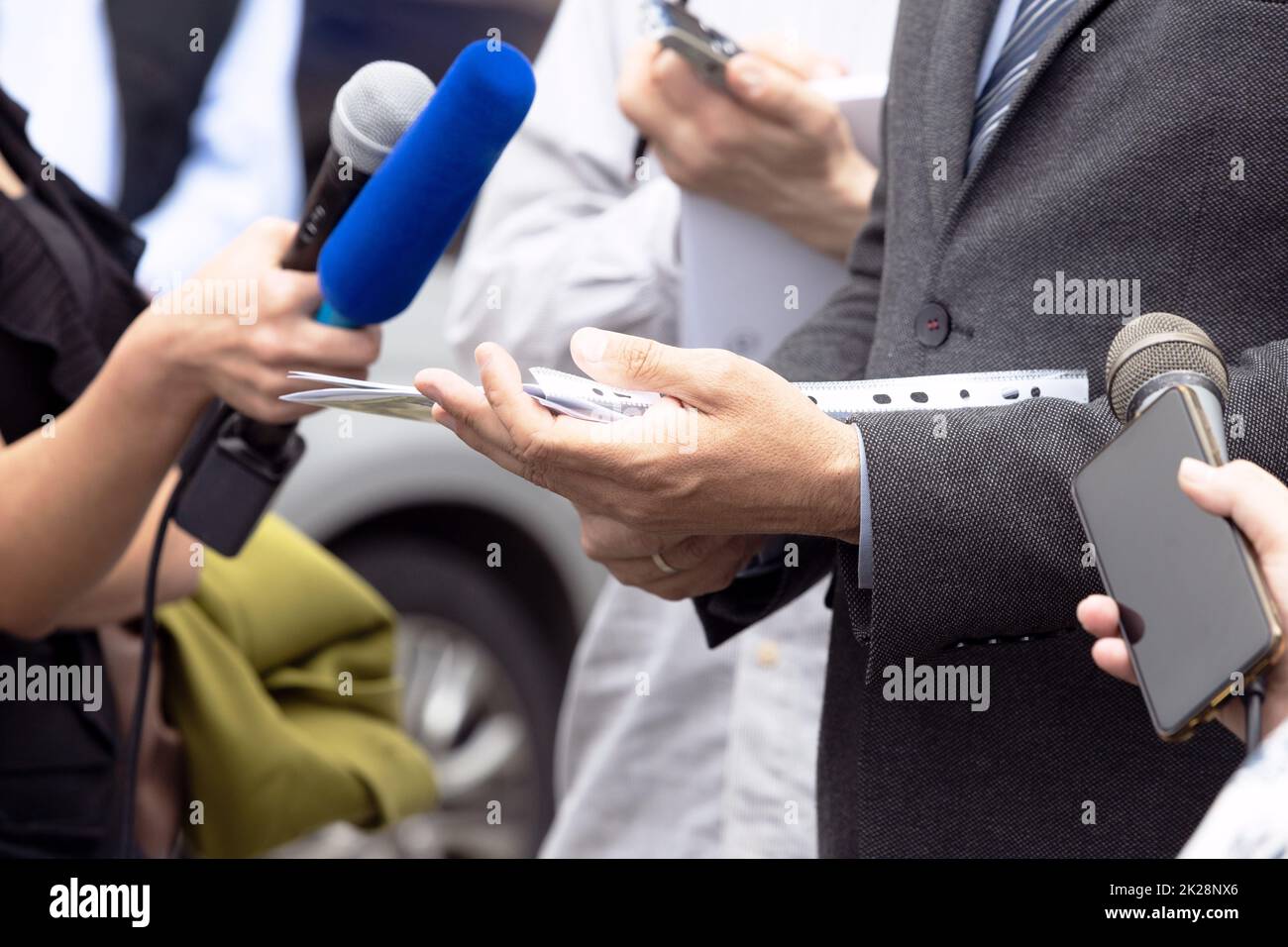 Business person or politician talking with journalists and reporters at news conference Stock Photo