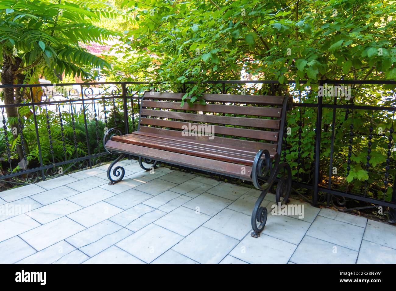 Beautiful forged bench in a well-maintained place Stock Photo