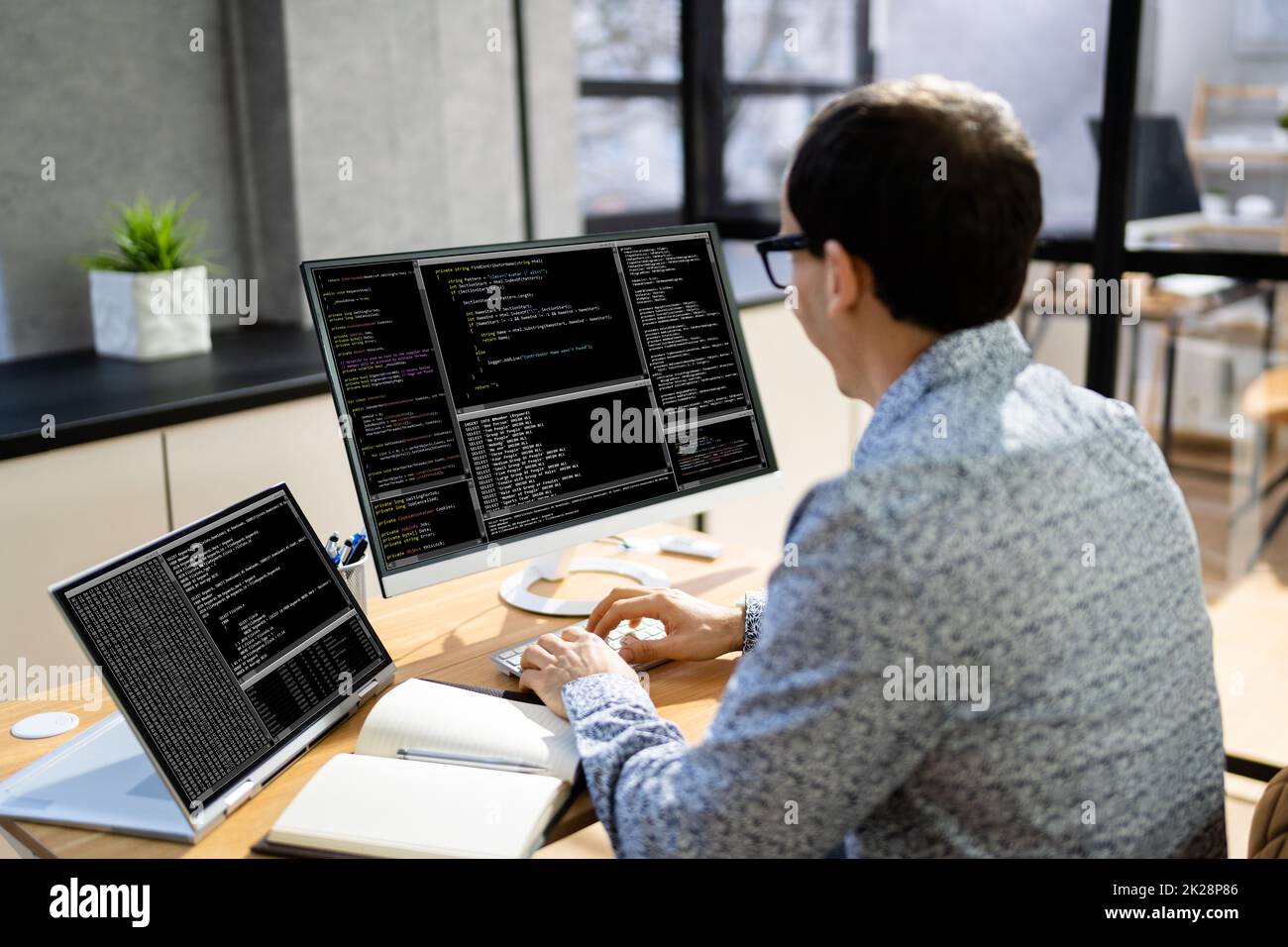 Computer Programmer Writing Program Code On Computer Stock Photo