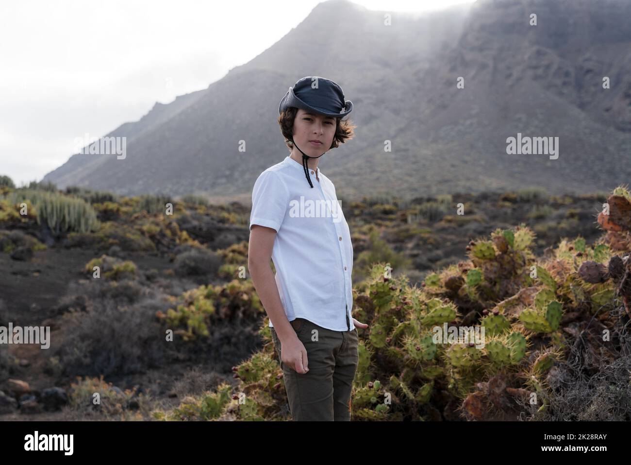 Portrait of a teenager against the backdrop of the Los Gigantes cliffs. Tenerife. Canary Islands. Spain. Stock Photo