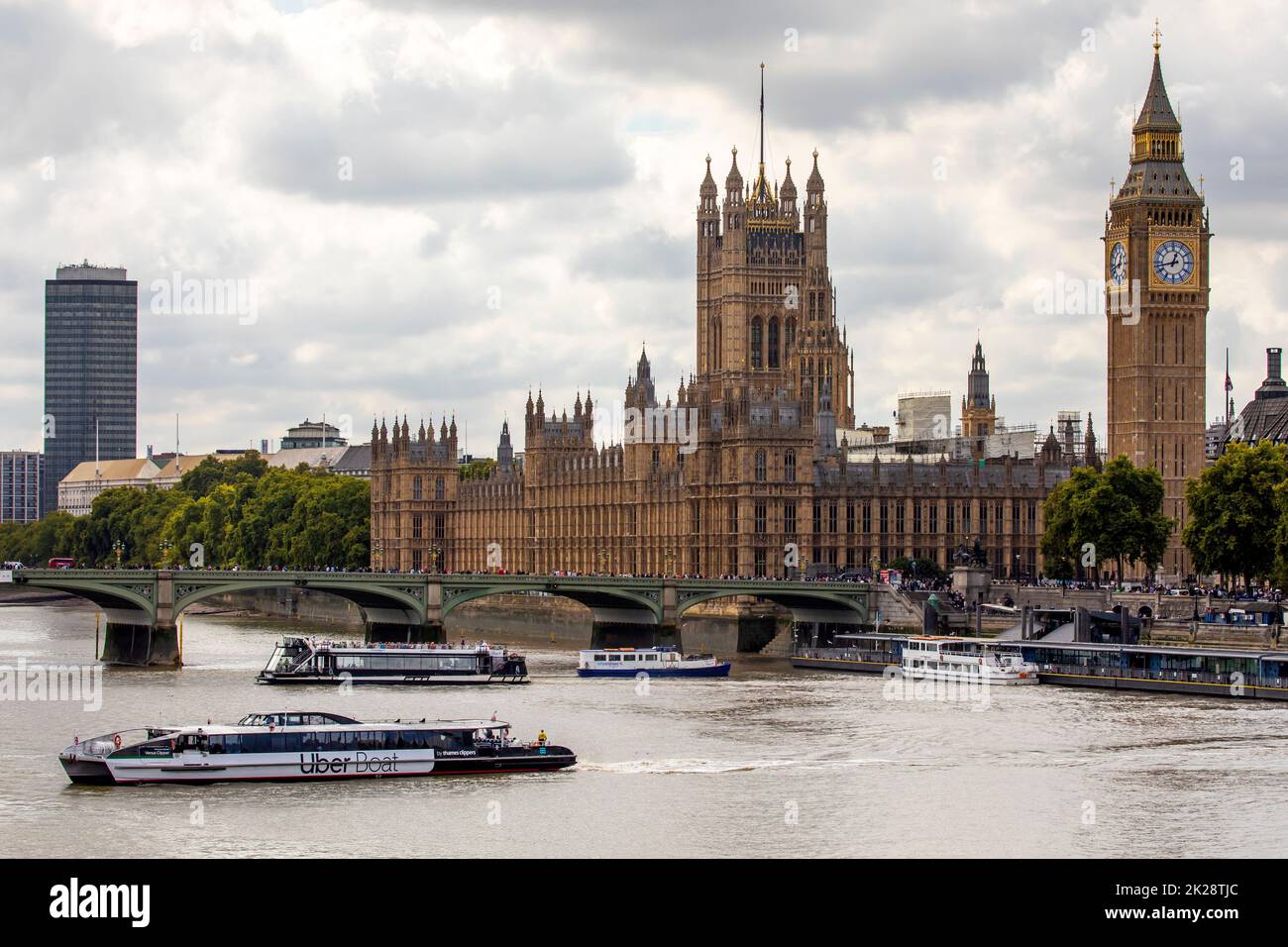London, UK - September 14th 2022: An Uber Boat on the River Thames in London, UK, with the magnificent Palace of Westminster in the background. Stock Photo