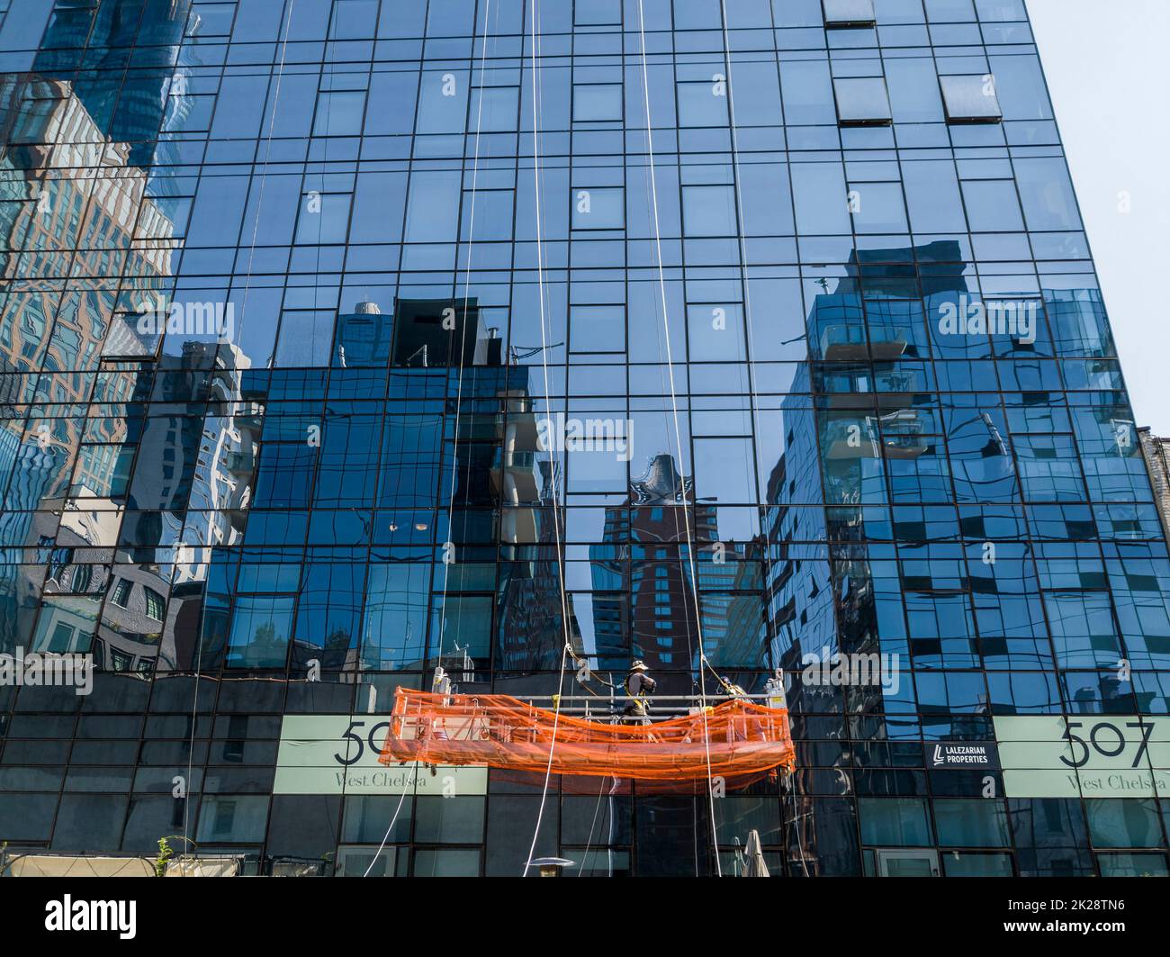 Workers suspended on a scaffold in the Chelsea neighborhood of New York