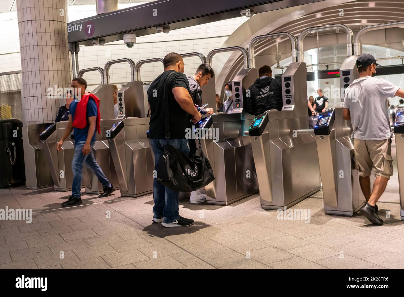 Masked and mask-less travelers enter and depart the West 34th St-Hudson Yards subway terminal in New York on Wednesday, September 7, 2022. NYS Gov. Kathy Hochul announced that the mask mandate on subways, buses and commuter rail has been lifted. (© Richard B. Levine) Stock Photo