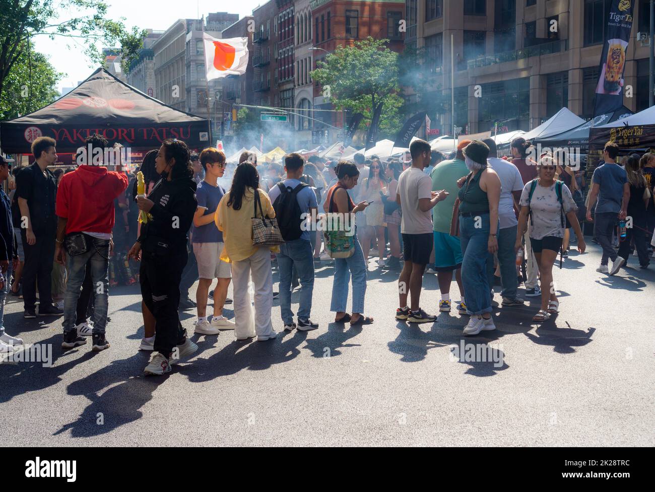 Visitors queue up at a street fair in Chelsea in New York, indulging in