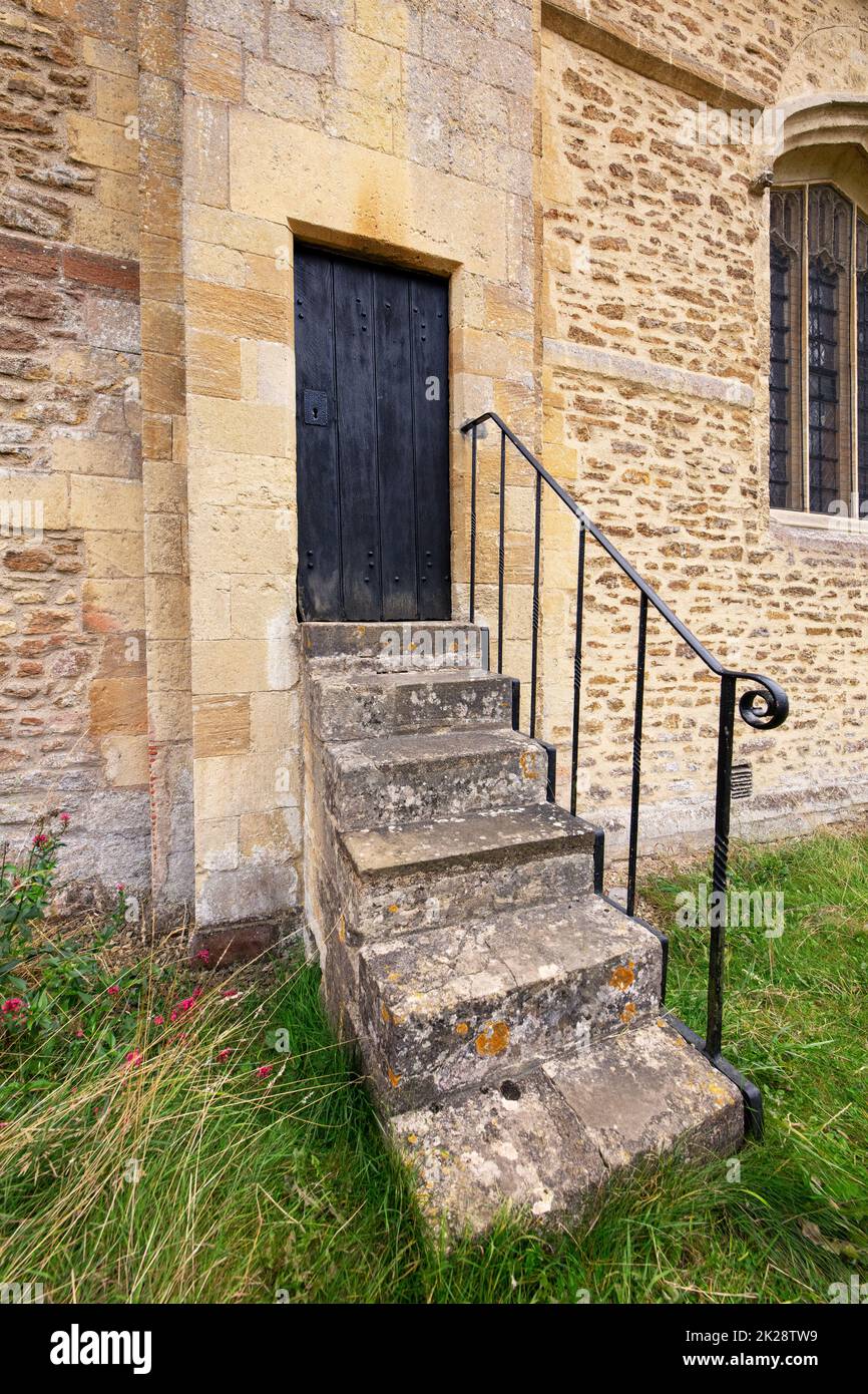 The Church of St Mary the Virgin, Iffley, Oxford; Romanesque, circa 1160. Grade I listed, showing a set of steps for the side entrance Stock Photo