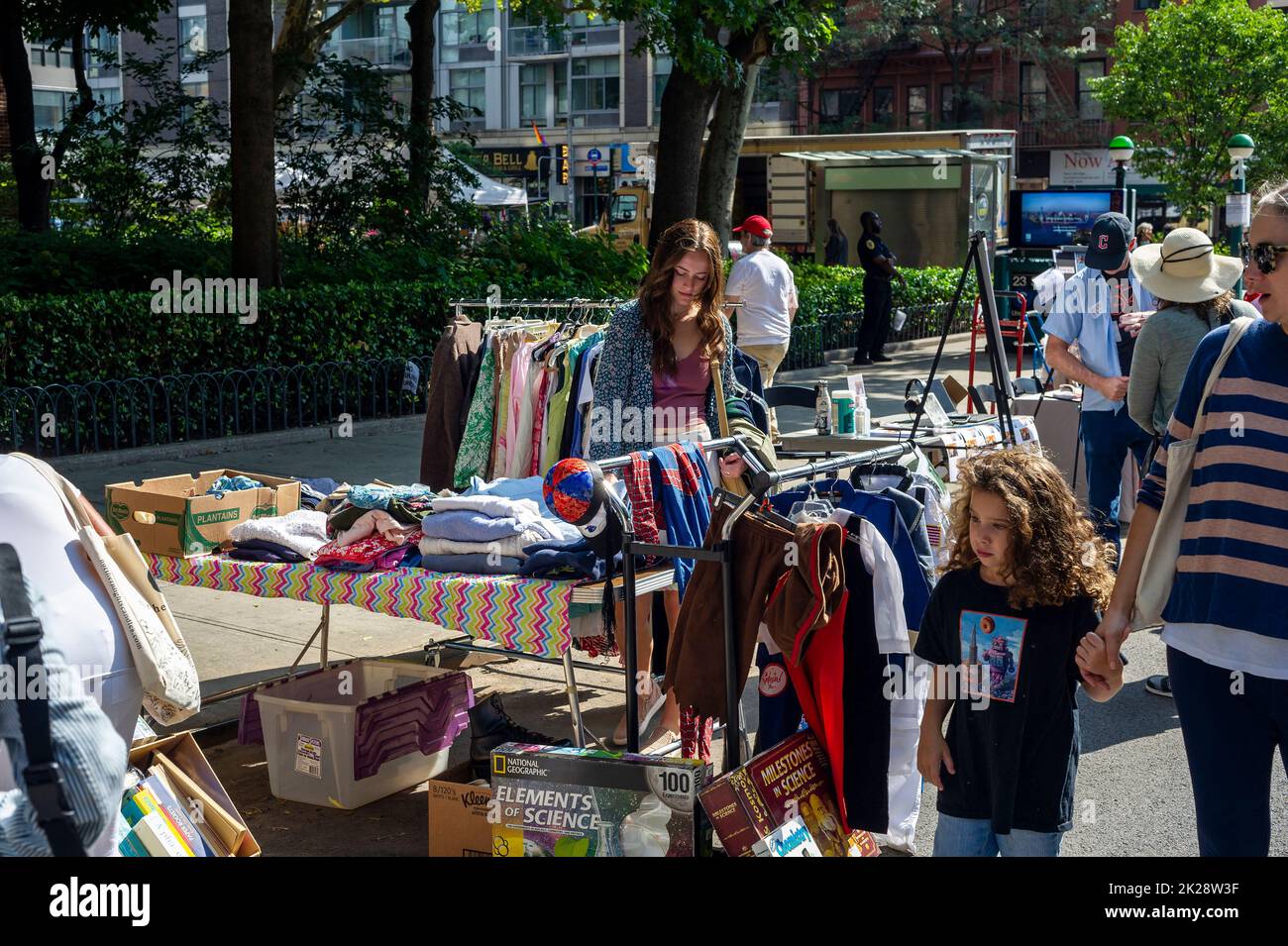 Shoppers search for bargains at the humongous annual Penn South Flea Market in the New York neighborhood of Chelsea on Saturday, September 17, 2022. The flea market appears like Brigadoon, only once every year, and the residents of the 20 building Penn South cooperative have a closet cleaning extravaganza. Shoppers from around the city come to the flea market which attracts thousands passing through.  (© Richard B. Levine) Stock Photo