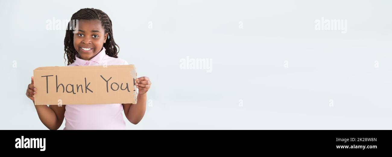 African Child Girl Holding Thank You Sign Stock Photo