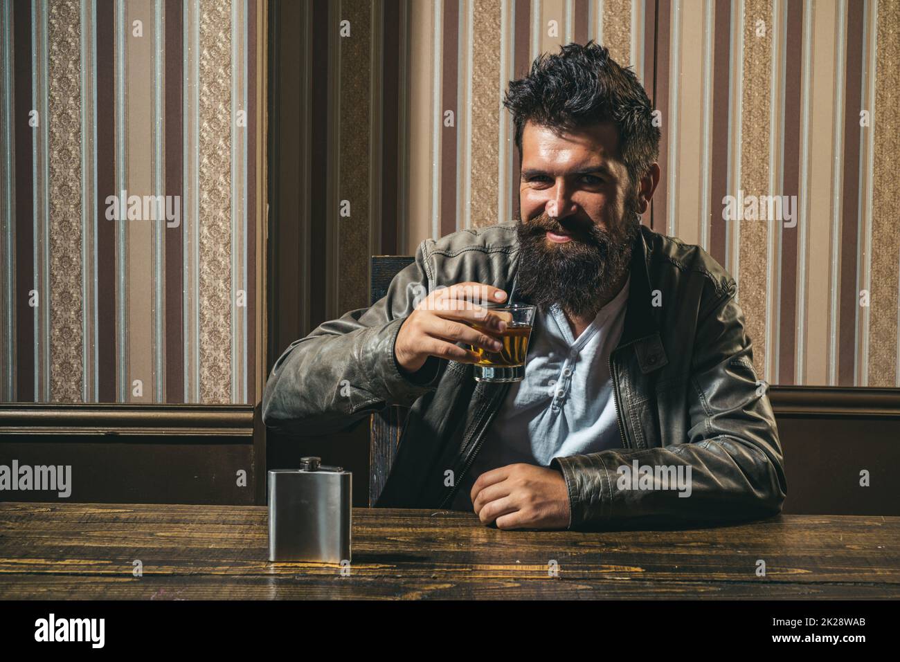 Tasting and degustation concept. Bearded man with glass of whiskey. Stock Photo