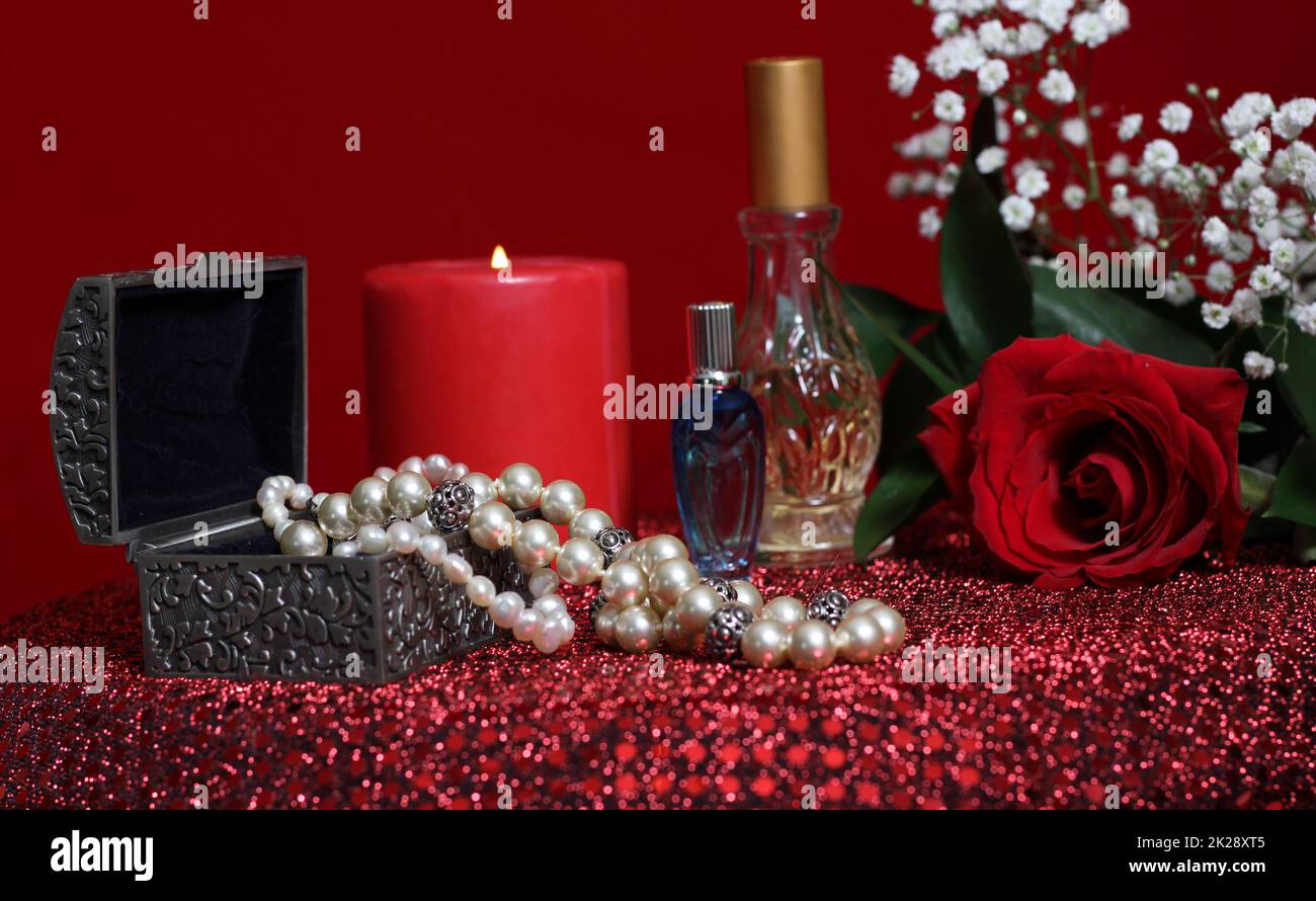 Candle and Rose With Perfume on Red Velvet Background Stock Photo