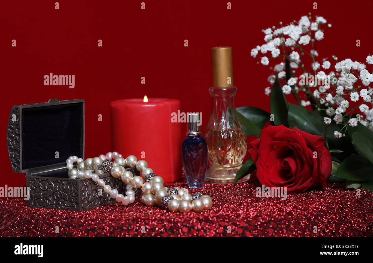 Candle and Rose With Perfume on Red Velvet Background Stock Photo