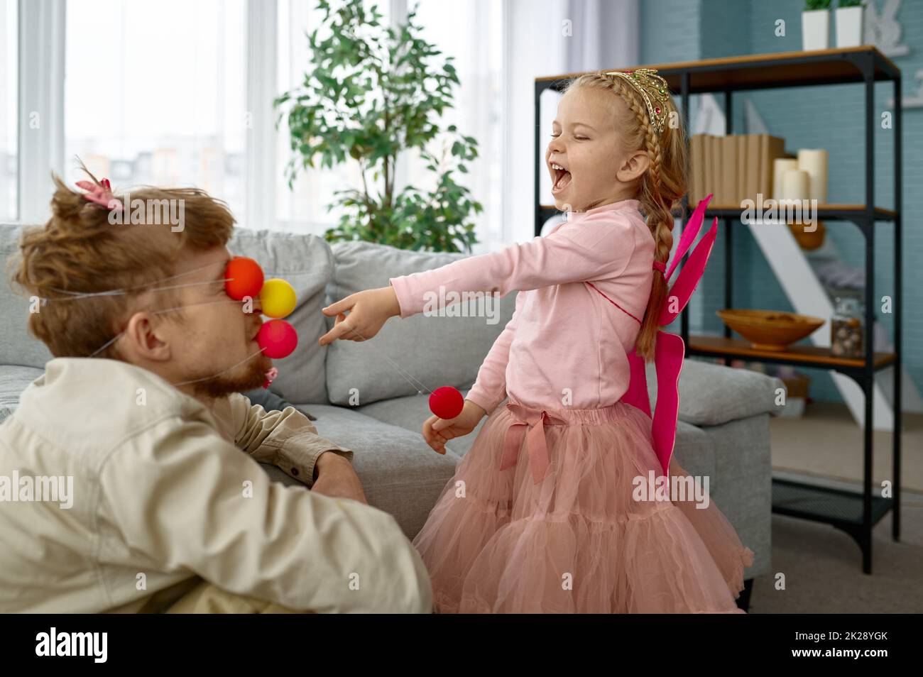 Playful father and daughter enjoy game together Stock Photo