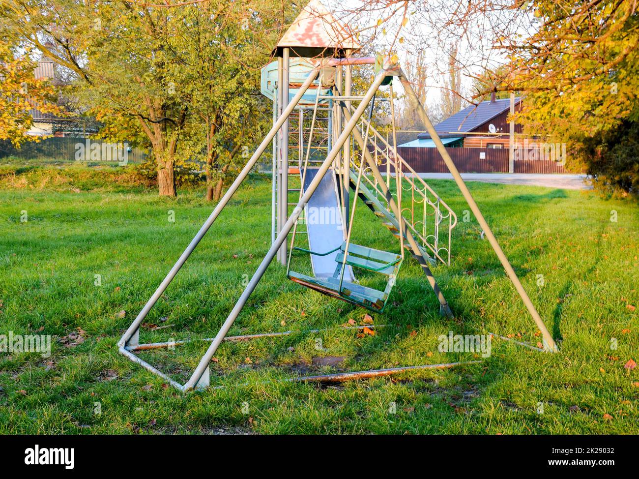 Children playground. Swings and a slide to slide Stock Photo