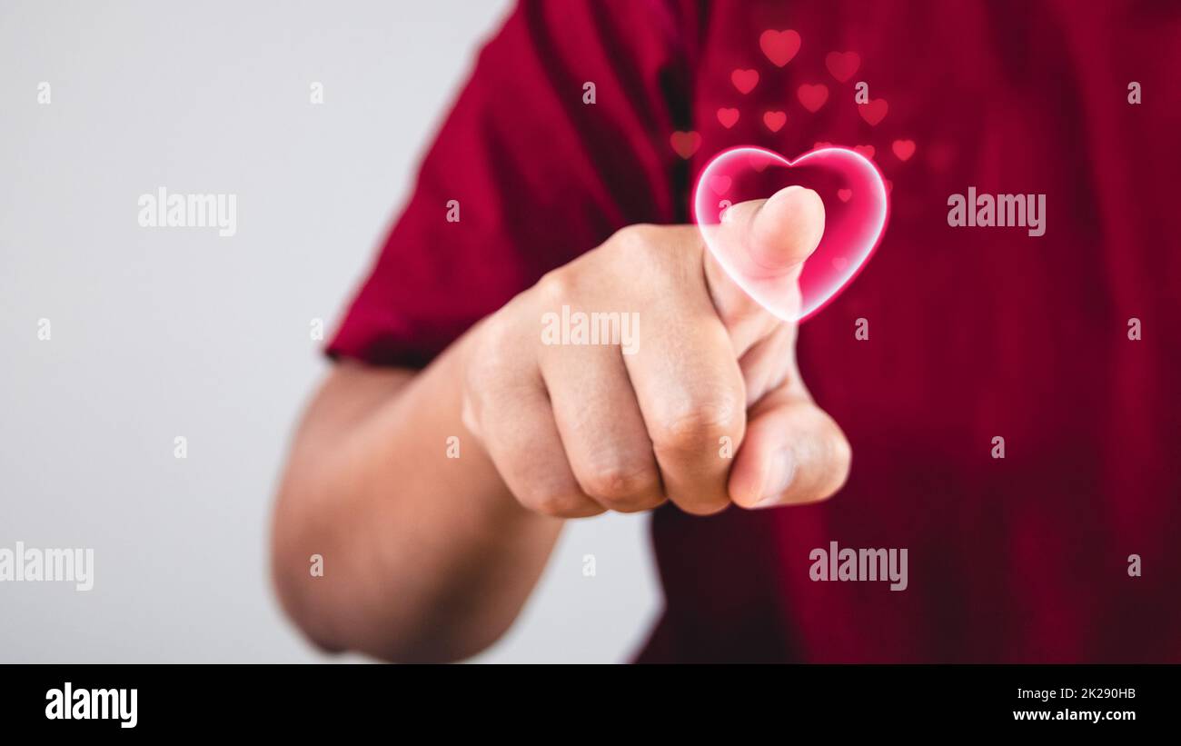 The heart is pointed by index finger. Valentine's concept with copy space. Stock Photo